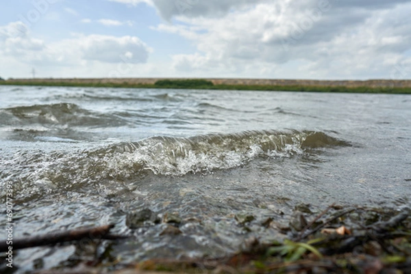 Fototapeta Wave beating against the shore.