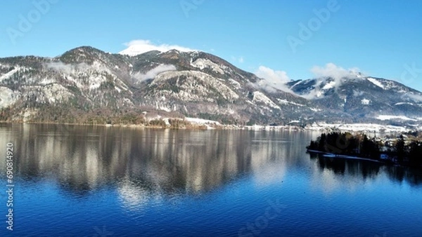 Fototapeta Beautiful view of the mountains and lake. Against the background of blue clouds. Winter