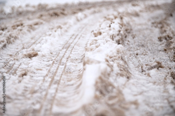 Obraz Tracks from a passing car, on the first snow. A car drove through the first white snow and left tread marks.