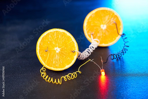 Fototapeta Free energy electricity generator using oranges.