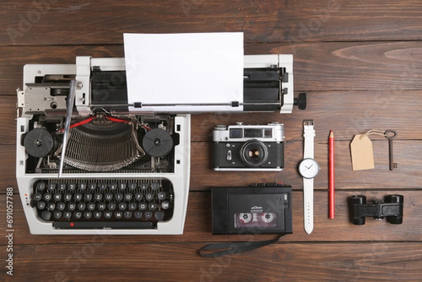 Fototapeta Journalist or private detective workplace - typewriter, camera, hat, recorder and other stuff, flat view above