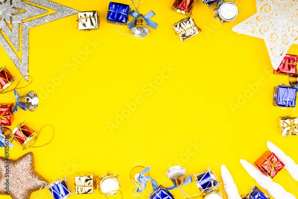 Fototapeta Christmas background. Bright Christmas frame. New Year banner Template with gift boxes, stars, bells, toys, decorations. Copy space. Winter holidays New Year. Top view photo for message or advertising