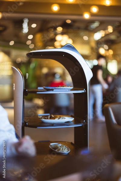 Obraz robot waiter serving food in a restaurant