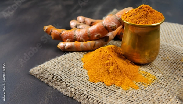 Fototapeta Ginger root and ginger powder in copper bowl on jute cloth