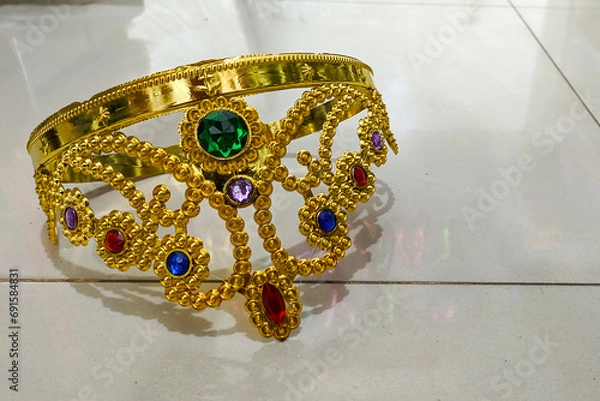 Obraz Inverted gold plastic queen crown on the floor with copy space