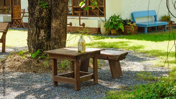 Fototapeta Chairs and table in an outdoor summer garden. garden chairs outside in the garden with lots of trees. Rest in the garden. Cottage with garden. Vacation at home