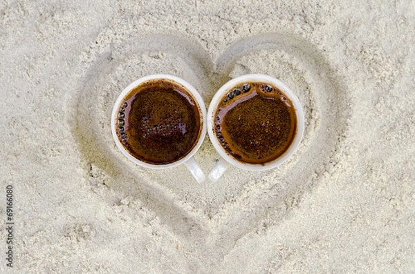 Obraz two cups with hot coffee on sand