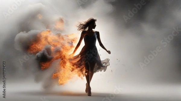 Fototapeta A modern abstract background with burst smoke with fire, in that fire a silhouette female model in a dress walking with confidence and unharmed