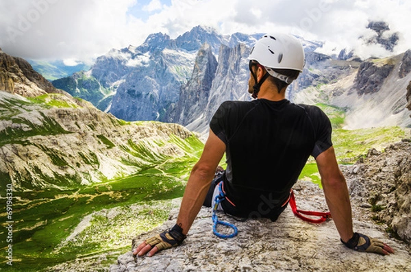 Obraz Climber on via ferrata Torre di Toblin, resting on the top