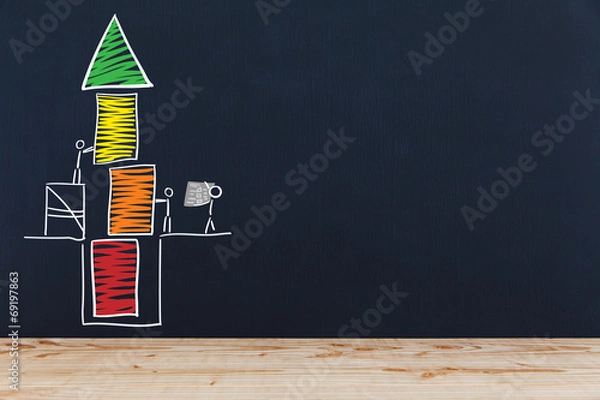 Obraz Stichmännchen bauen Turm auf einer Tafel