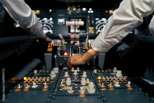 Fototapeta close-up of the cockpit of a passenger plane with many buttons on the control panel of an airplane flight simulator