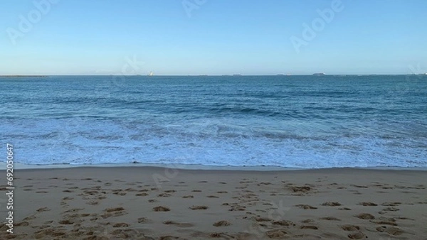Fototapeta View of the beach and the Atlantic Ocean at the end of afternoon.