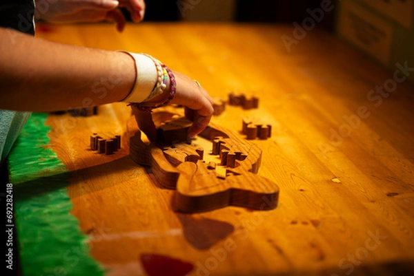 Fototapeta a kid playing with a wooden puzzle