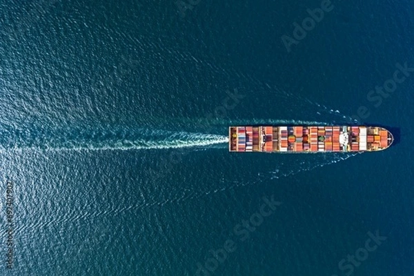 Fototapeta Aerial top view container ship in export and import business and logistics. Shipping cargo to harbor by crane.