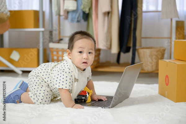 Obraz A little Asian boy crawled on the floor in the living room. A baby is playing in the children's room of the house.