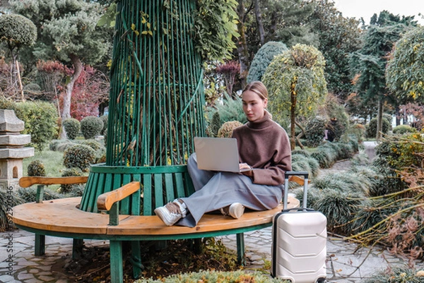Fototapeta Business travel.Remote work. freelancer works remotely business travel.workation,remotely work,work life balance,digital nomad,workation,work travel,remot work.Travelling.Work from vacation remotely