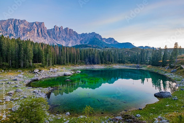 Obraz Emerald waters, misty Spruce forests, and breathtaking views define Lago di Carezza, an alpine favourite in Val d'Ega, South Tyrol, and the Dolomites.