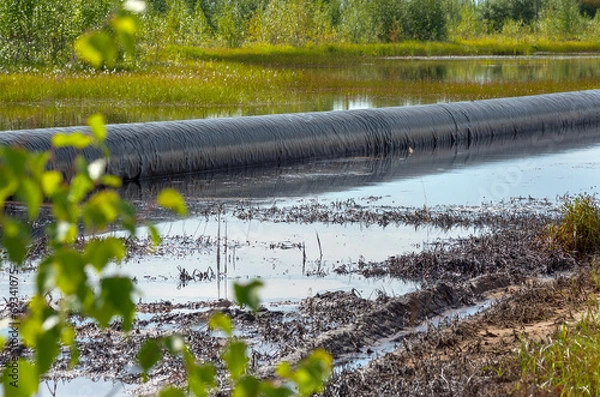 Obraz Spilled oil around the oil pipeline