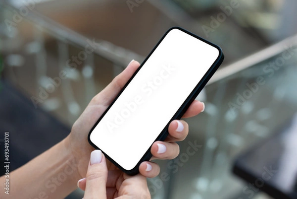 Fototapeta woman hand hold phone with isolated screen background of  street