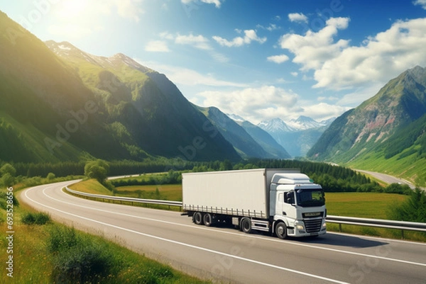 Fototapeta A white cargo truck with a white blank empty trailer for ad on a highway road in the Europe