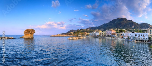 Obraz Townscape of Lacco Ameno at dusk in Ischia Island, Italy. View of the Fungo mushroom rock, a huge block of tuff shaped by the incessant erosion of the sea and the wind, famous symbol of Ischia.