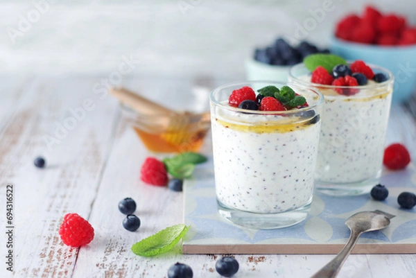 Obraz Greek yogurt in glasses with berries and quinoa