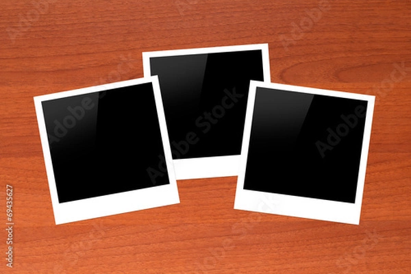 Obraz Blank Picture Frames on Wooden Table