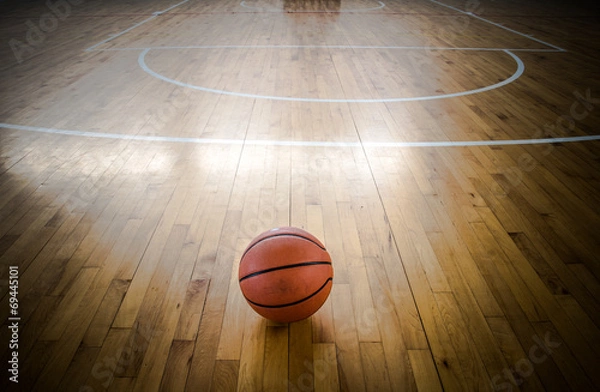 Fototapeta Basketball ball over floor in the gym