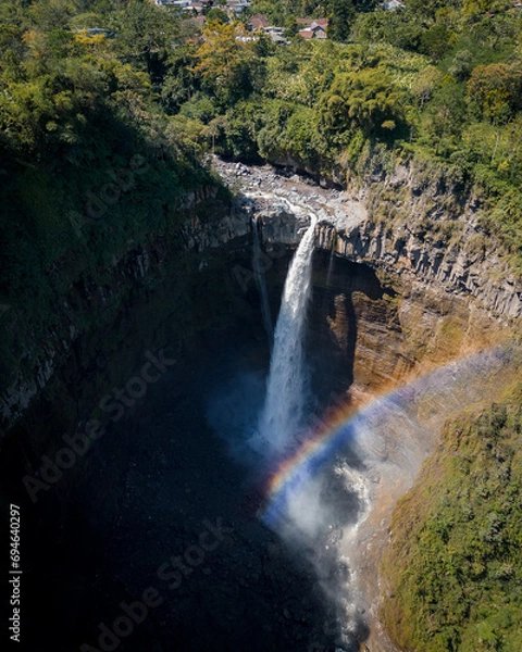 Fototapeta Drone view of a waterfall near Gunungsriti. Rainbow. East Java. Indonesia. 