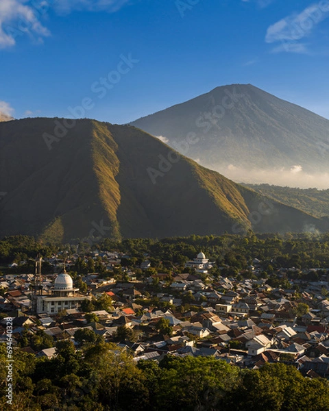 Fototapeta View from above of Sembalun, a small town in the northern part of the island of Lombok. Golden hour. Mount Rinjani in the distance. Indonesia