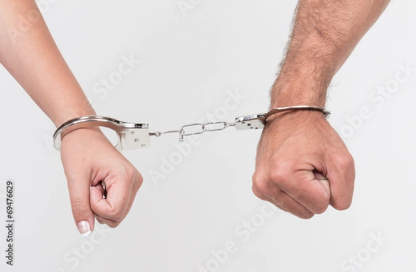 Obraz Man and woman's hands handcuffed together