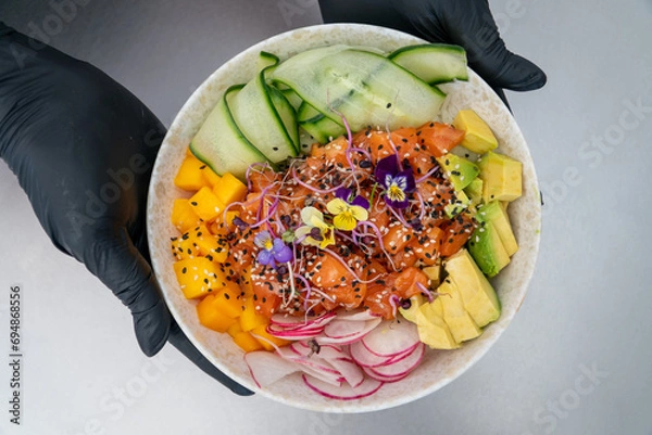 Obraz an image overlooking a chef presenting a freshly prepared salmon poke bowl 