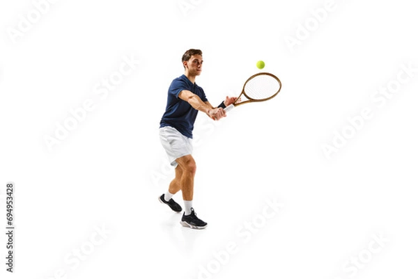 Fototapeta Young athletic man, tennis player in motion, hitting ball with racket isolated over white background. Dynamic game. Concept of professional sport, competition, game, math, hobby, action