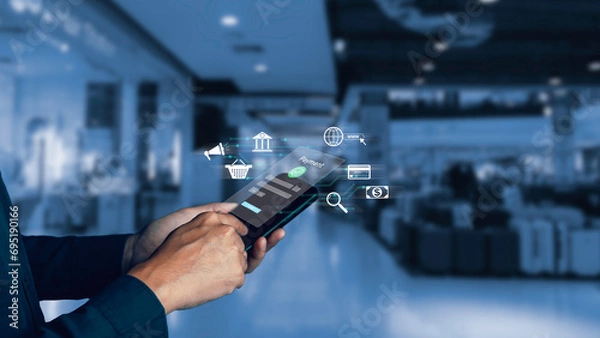 Fototapeta Buy now pay later online shopping concept. Hands holding mobile phone on blurred store as background. Online shopping. Paying after delivery. Complete the payment after purchase at no added cost.