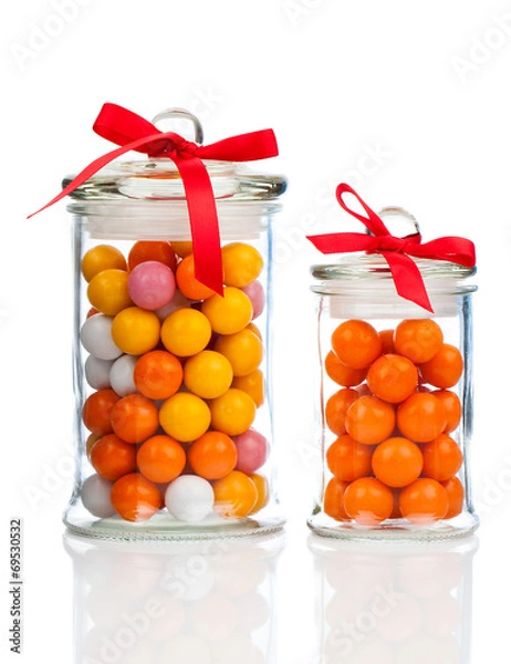 Fototapeta Colorful background of assorted Gumballs in  glass jar,  isolate