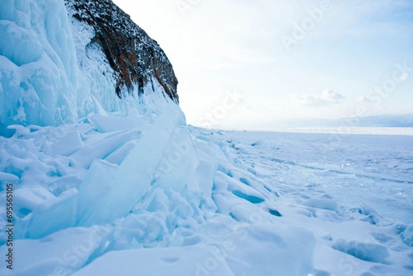 Obraz Beautiful view of a large ice rock on frozen Lake Baikal and large cracked ice floes in cold evening time 