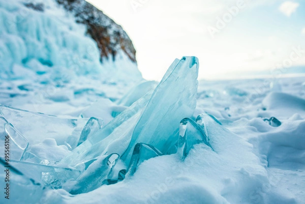 Obraz Beautiful view of a small cracked ice floe on frozen Baikal lake in evening time 
