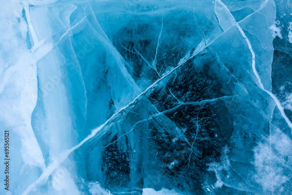 Obraz View from above on beautiful frozen Baikal lake with cracks on the transparent ice surface background for adverting content  