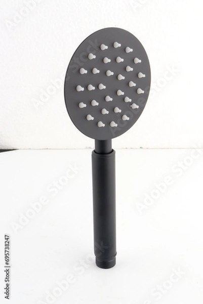Fototapeta The black hand shower features a sleek, modern design that adds a stylish touch to any bathroom.