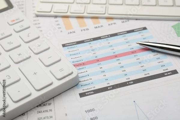 Obraz Pen, calculator and computer keyboard on accounting documents with data, closeup