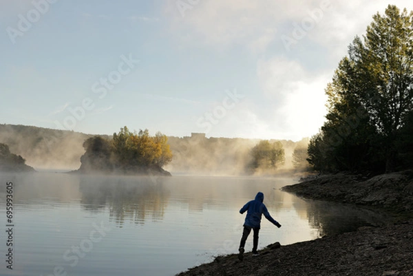 Fototapeta silhouette in front of a misty lake