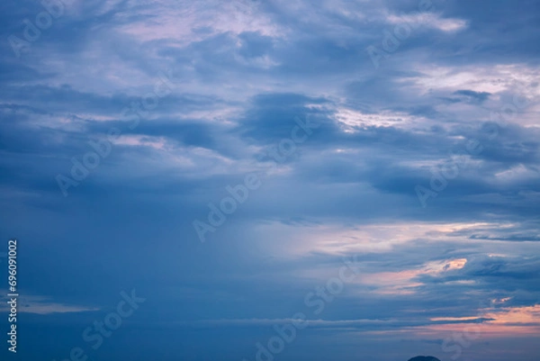Fototapeta Stormy heavy violet sky with dark rainy gloomy dramatic clouds surrounded by hazy mystical atmosphere on the horizon 