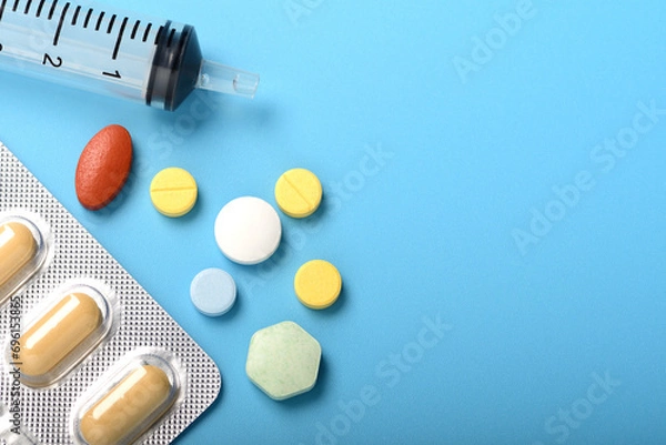Obraz Concept of healthcare and medicine. Top view, copy space , Assorted pharmaceutical medicine pills, tablets and capsules. Close up of many different pills on blue background. Pills background. Free spa
