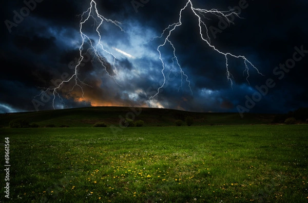 Obraz Thunderstorm with lightning in green meadow