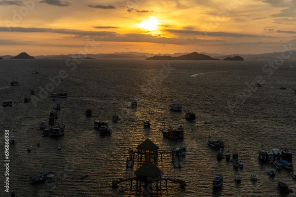 Obraz Tour Boats anchored at port of Labuan Bajo during sunset.