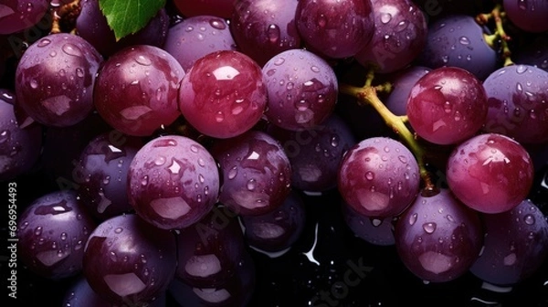 Fototapeta Fresh grapes with glistening droplets of water viewed from above