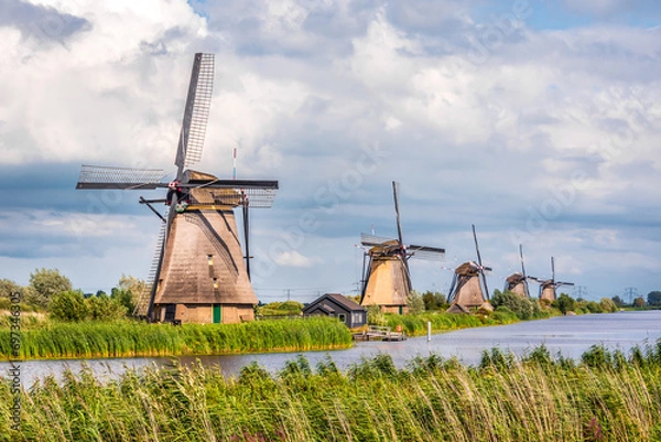 Fototapeta General view of the Overwaard windmills, part of the Kinderdijk mills  near Rotterdam, Netherlands, built in 1740 to drain the Alblasserwaard polder, under a stormy sky.