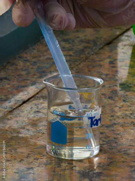 Fototapeta Pipetting a Chemical in a Beaker