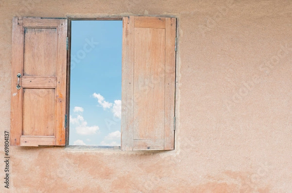 Fototapeta Blue sky with clouds seen through the window.