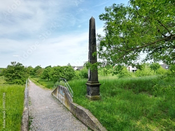 Fototapeta Obelisk on the long-distance cycle path in Dessau on the Elbe embankment
